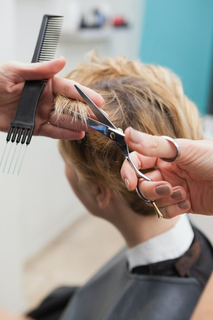 Hairdresser cutting a customers hair at the hairdressers